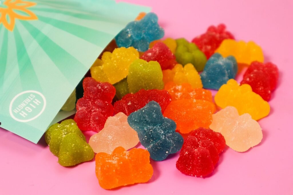 The Art of Drawing Readers In: Your attractive post title goes here Close-up of colorful gummy bears spilling out of a high-strength package on a pink surface.